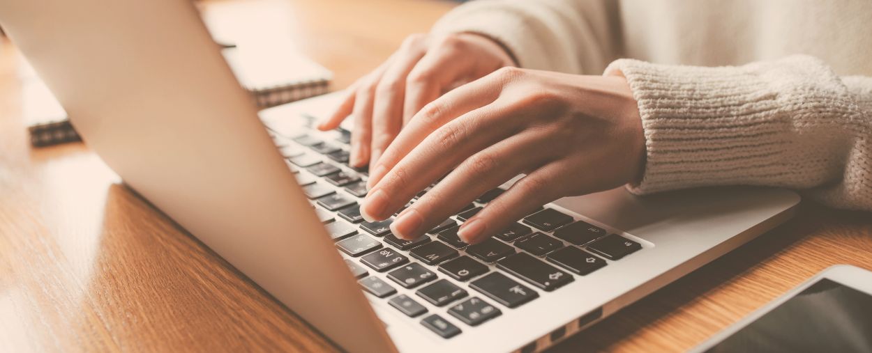 hands typing on a laptop